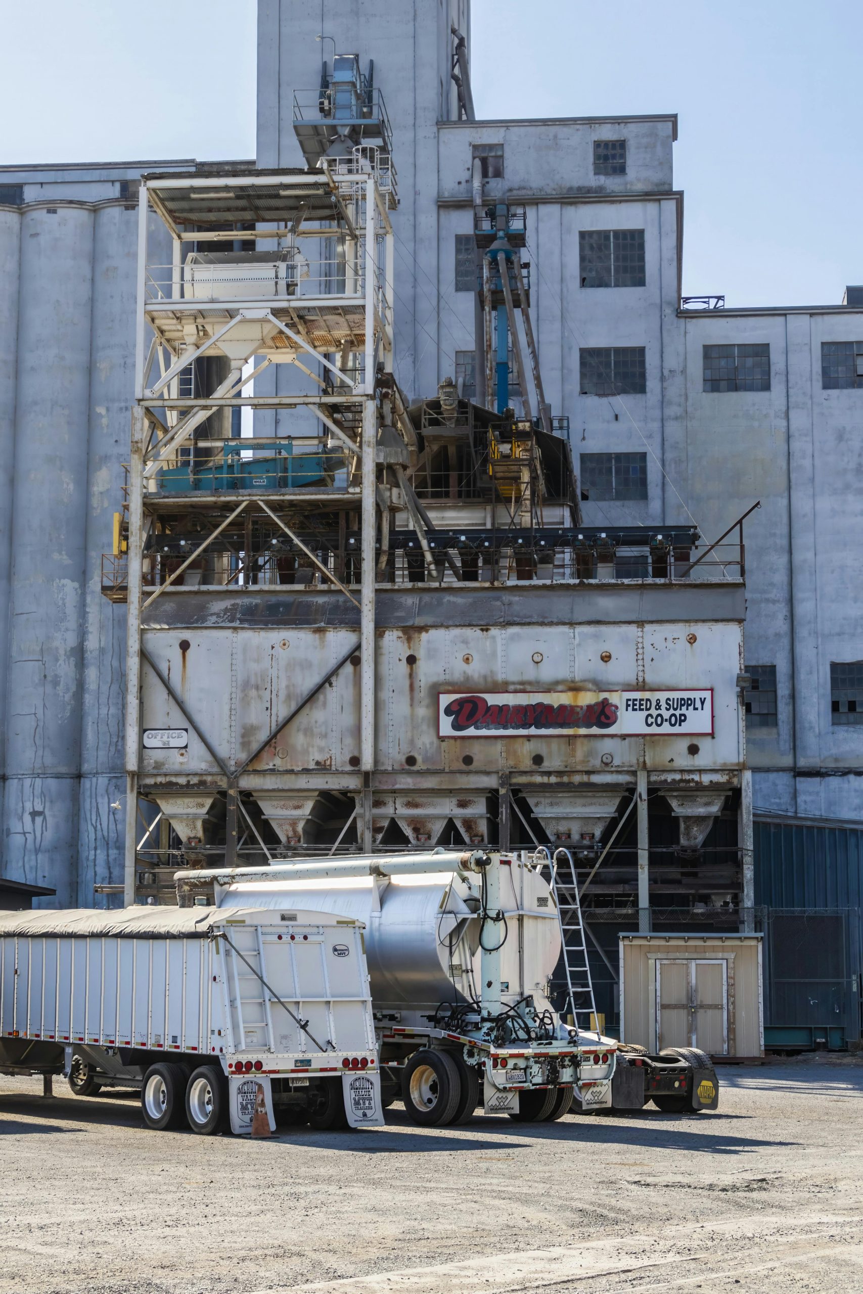 Industrial scene featuring a truck loading at a warehouse facility.